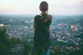 woman looking at evening cityscape